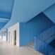 interior hallway of a school with blue walls and ceilings
