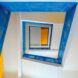 a shot of a spiral staircase with blue rails