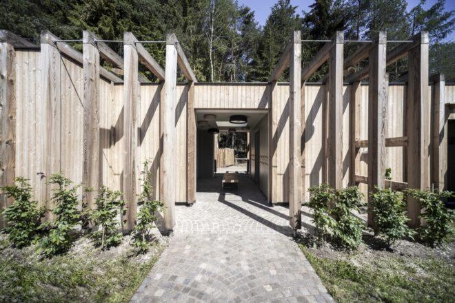 a timber lake house with overhanging wood beams