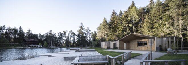 a dock on the lake, featuring a timber lake house