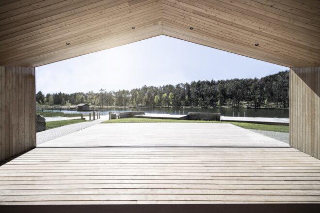 a view from inside the lake house, looking out on the lake and trees