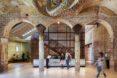 arched doorways leading to a glowing white reception desk
