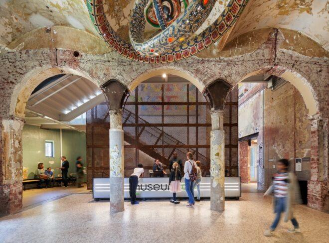 arched doorways leading to a glowing white reception desk