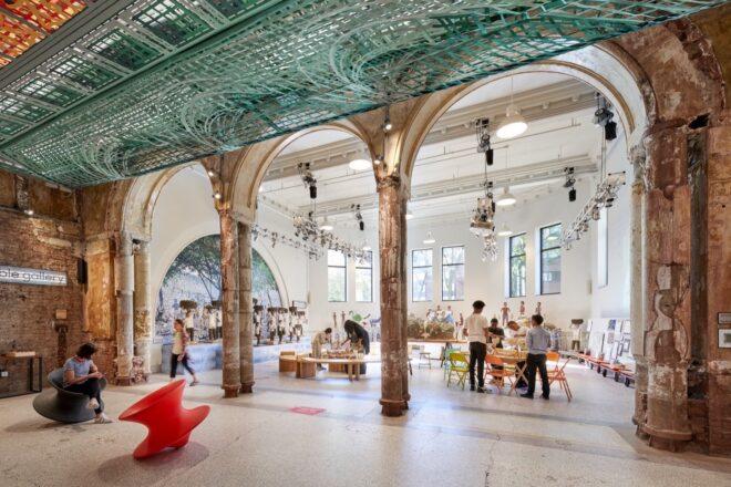 arched doorways leading to a bright room with many tables