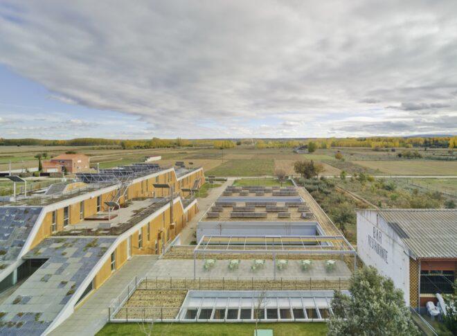 aerial view of tan buildings covered in solar panels