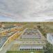 aerial view of tan buildings covered in solar panels