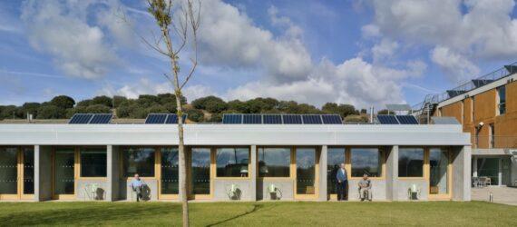 long gray building topped with solar panels