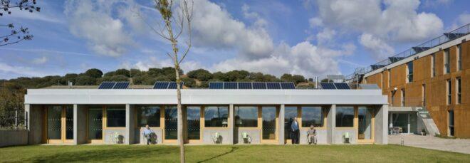 long gray building topped with solar panels