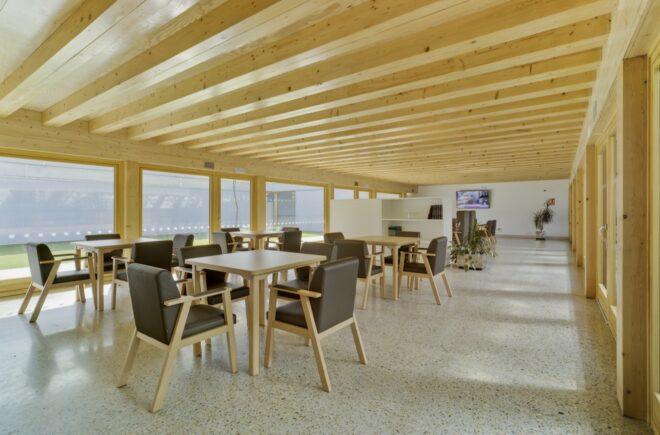 wood tables and dark chairs in a lobby