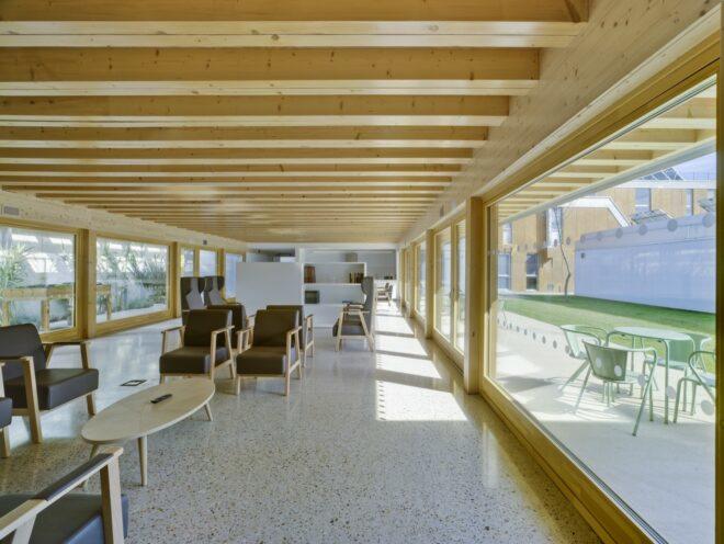 dark chairs in a communal living area with wood-beamed ceilings
