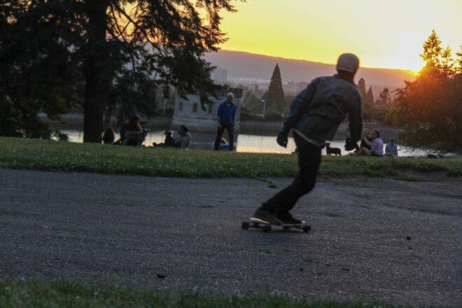 evening shot of man riding a skateboard