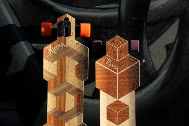 two wooden skateboards with various color tones