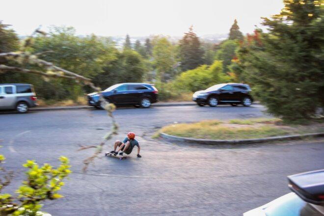 man crouched down riding a skateboard