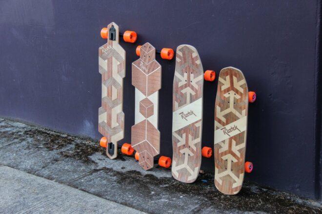 four skateboards lined up against a wall