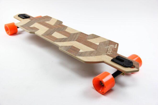 wooden skateboard with orange wheels