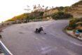 man riding a skateboard around curve