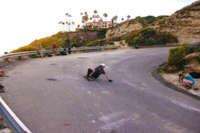 man riding a skateboard around curve