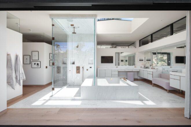 a bathroom decorated with white fixtures
