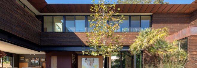 a closeup of a cabin with trees in front of it