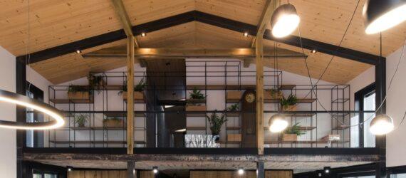 a close-up of the second floor, showcasing black frame accents and light-colored wood throughout the home