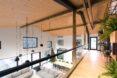 the second level of a home with light-colored wood accents and neutral walls and furniture