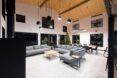 a living room with neutral colors, including three gray sofas