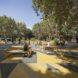 benches in a park with yellow and gray floors