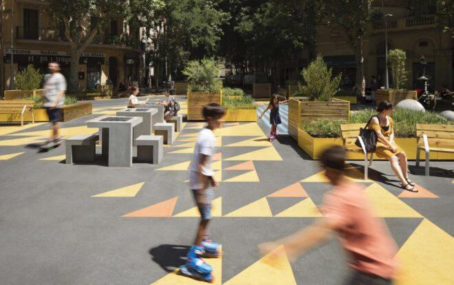 kids roller skating in a plaza with colorful floors and several planter boxes