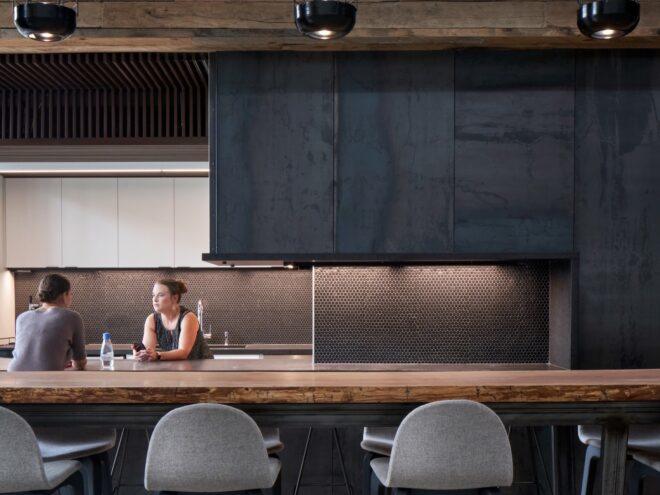office kitchen with black walls, dark backsplash and wood counters
