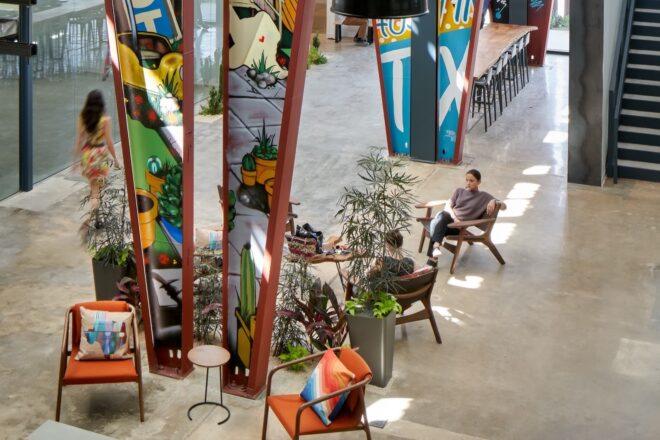 orange and black chairs near colorfully painted steel support beams