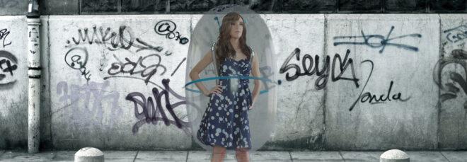 rendering of person wearing a bubble-like shield around their body in a public street