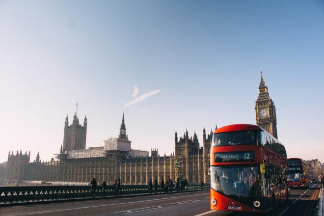 buses and pedestrians going past Big Ben in London