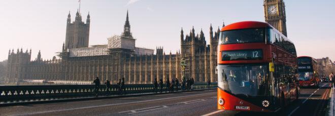 buses and pedestrians going past Big Ben in London