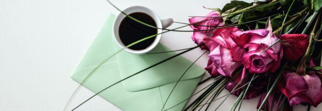 green envelope, coffee and pink roses