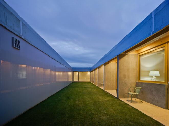 green yard near a building with separate patios