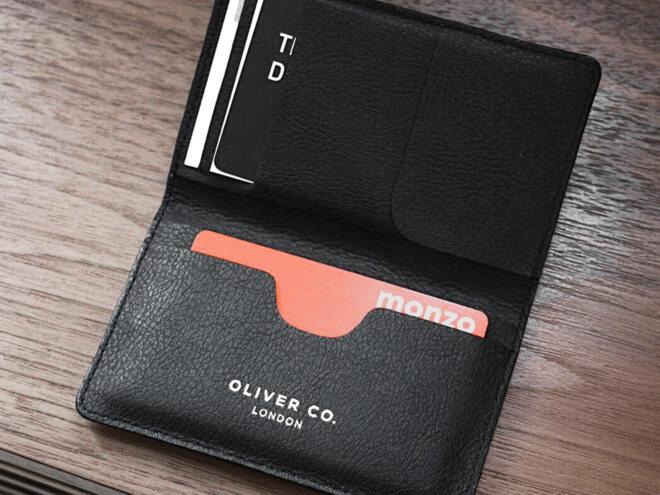 Cards inside a vegan leather wallet on a wood table