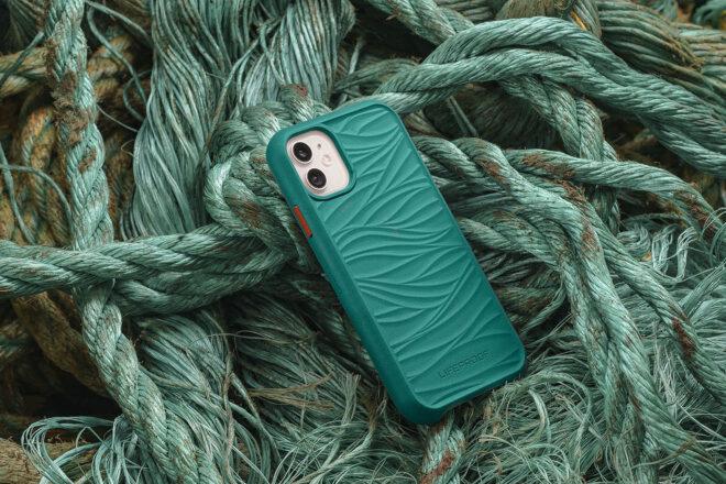 a phone in a teal case on a pile of old fishing nets and ropes