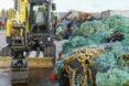 a tractor next to a pile of old fishing nets
