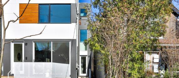 narrow, white three-story home