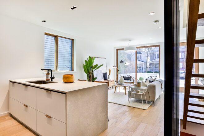 light wood kitchen island facing a living room
