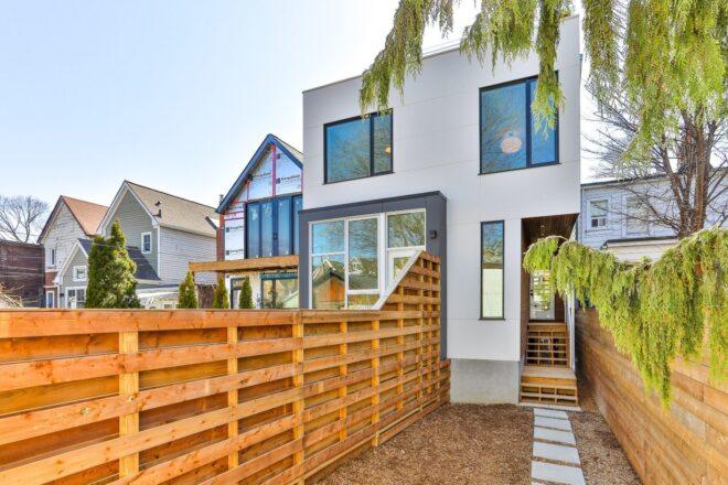 walkway leading to white three-story home
