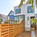 walkway leading to white three-story home