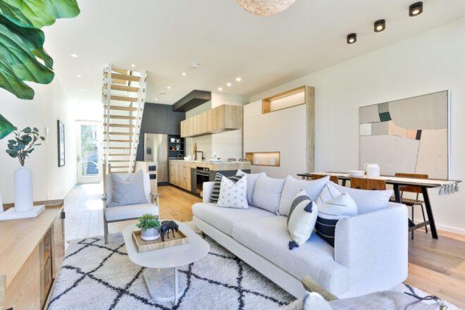 main living space with white sofa and printed rug