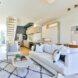 main living space with white sofa and printed rug