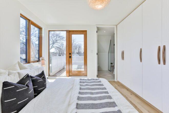 large bedroom with doorway leading out to porch