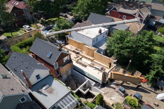 aerial view of people building a narrow home