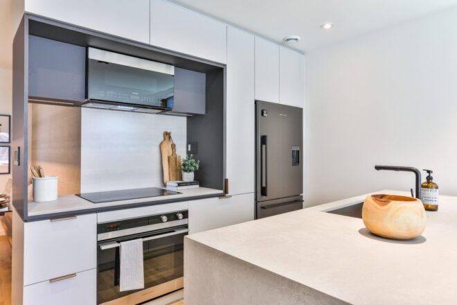 kitchen with white cabinets and large white island