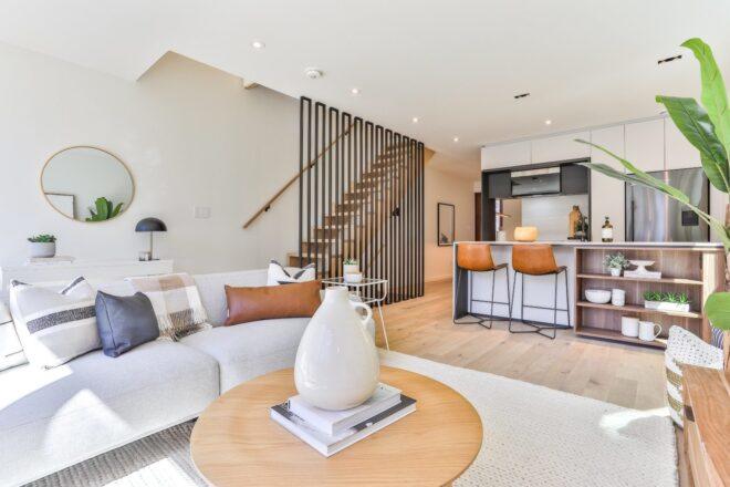 round coffee table near white sofa beside a staircase