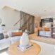 round coffee table near white sofa beside a staircase