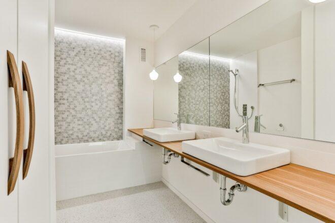 white bathroom with wood countertop